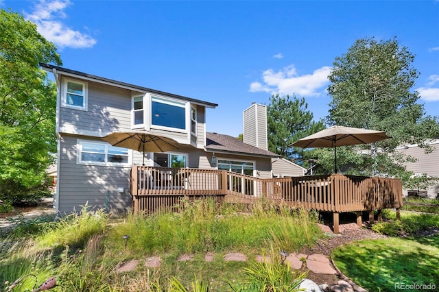 back of house with a wooden deck