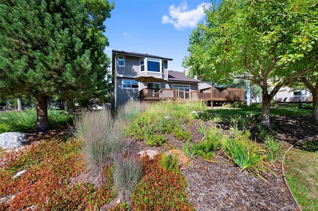 rear view of house with a wooden deck