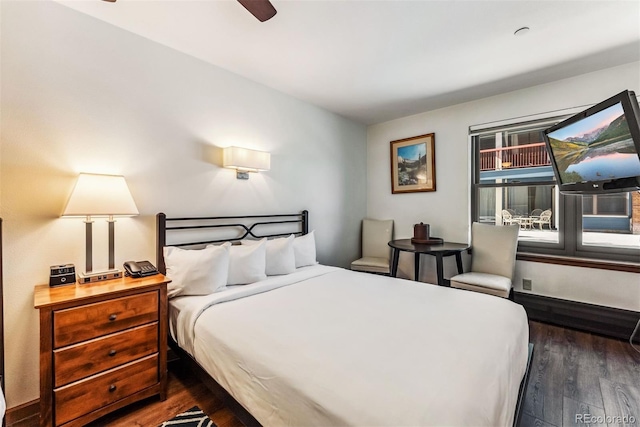 bedroom with ceiling fan and dark hardwood / wood-style flooring