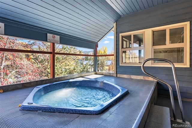 view of swimming pool featuring an in ground hot tub