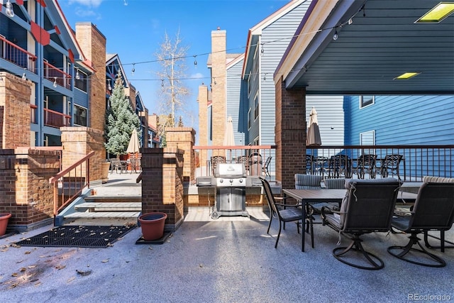 view of patio featuring area for grilling and a balcony