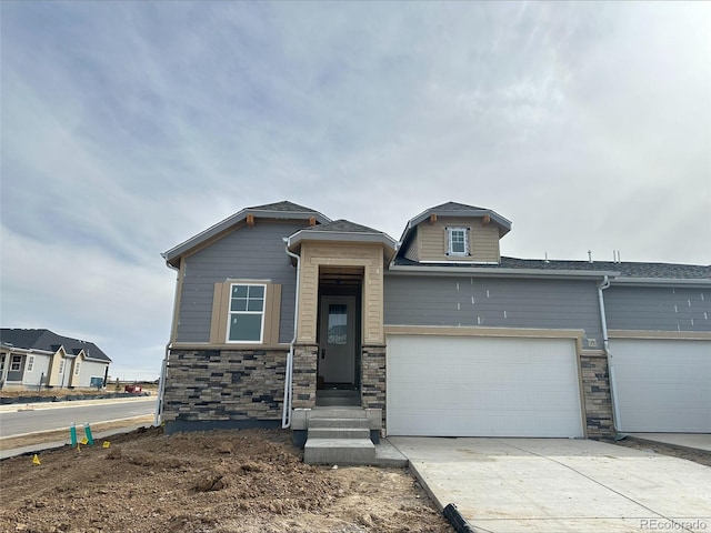 view of front of property featuring a garage and concrete driveway