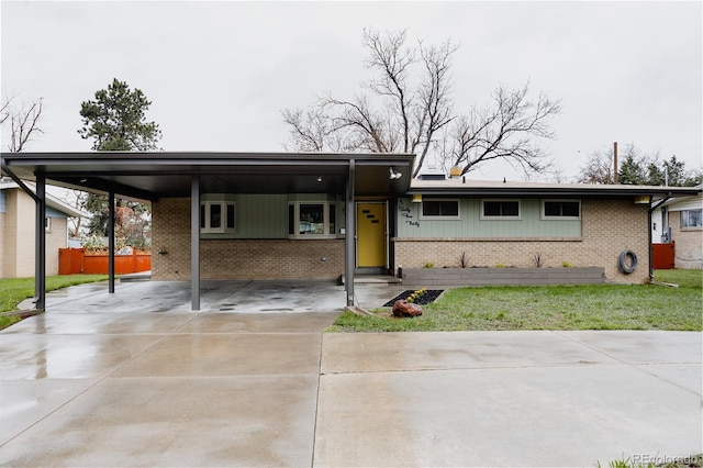 6530 W 26th Ave, Edgewater, CO 80214 - view of front of house with brick siding, concrete driveway, and a carport