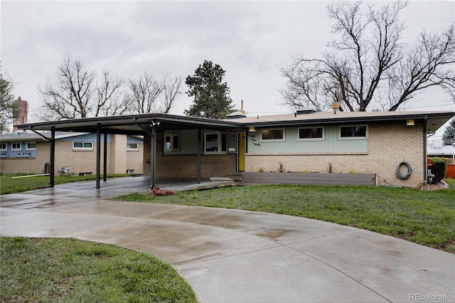 6530 W 26th Ave, Edgewater, CO 80214 - ranch-style house with brick siding, driveway, a carport, and a front yard