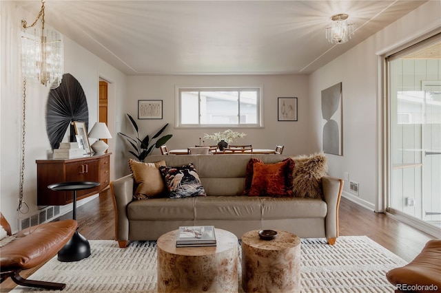 6530 W 26th Ave, Edgewater, CO 80214 - living area featuring wood finished floors, a chandelier, and baseboards