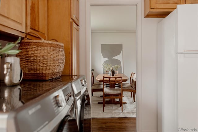 6530 W 26th Ave, Edgewater, CO 80214 - dining area featuring washing machine and dryer, crown molding, and dark wood finished floors