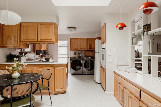 6530 W 26th Ave, Edgewater, CO 80214 - kitchen with washer and clothes dryer, white oven, light countertops, a skylight, and light flooring