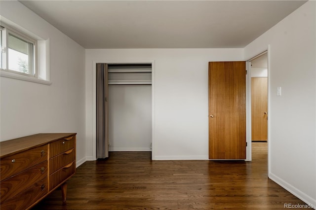 6530 W 26th Ave, Edgewater, CO 80214 - unfurnished bedroom featuring dark wood-style flooring, baseboards, and a closet