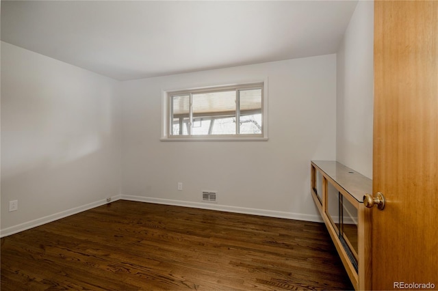 6530 W 26th Ave, Edgewater, CO 80214 - empty room with dark wood-style flooring and baseboards