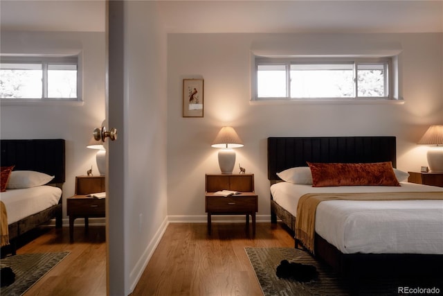 6530 W 26th Ave, Edgewater, CO 80214 - bedroom with wood finished floors, multiple windows, and baseboards