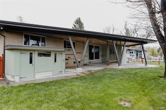 6530 W 26th Ave, Edgewater, CO 80214 - back of house featuring brick siding, a patio area, and a yard