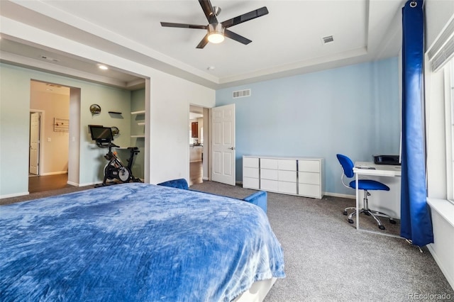 bedroom with carpet, a raised ceiling, visible vents, and baseboards