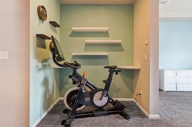 workout area featuring carpet and baseboards