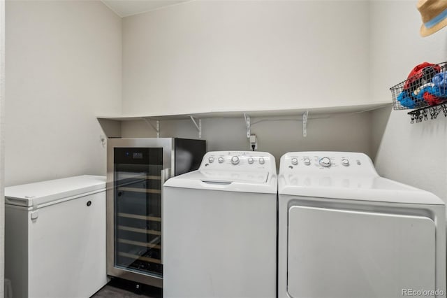 laundry area featuring beverage cooler, laundry area, and washing machine and clothes dryer