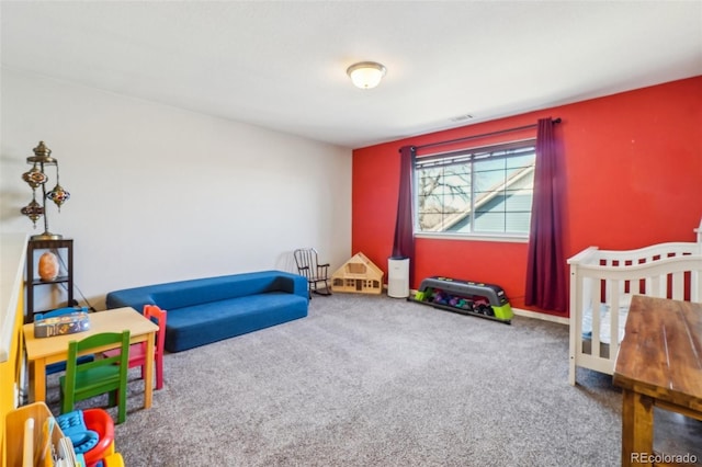 recreation room with baseboards, visible vents, and carpet flooring