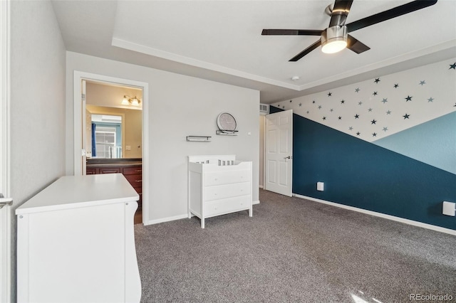 unfurnished bedroom featuring carpet floors, ceiling fan, ensuite bath, and baseboards