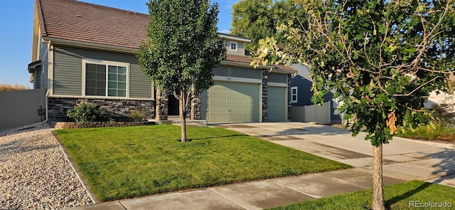 view of property hidden behind natural elements featuring driveway, stone siding, an attached garage, fence, and a front lawn