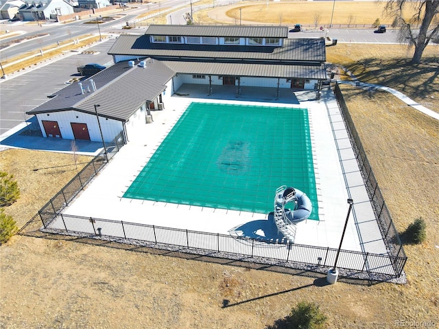 view of pool with an outbuilding and fence