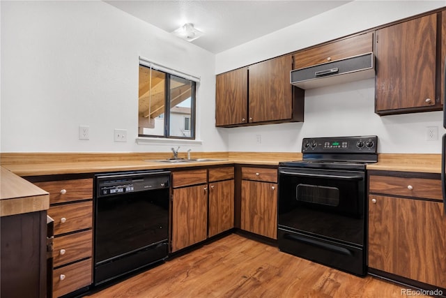 kitchen with exhaust hood, sink, black appliances, and light wood-type flooring