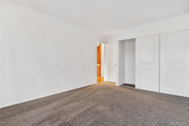 unfurnished bedroom featuring carpet and a closet