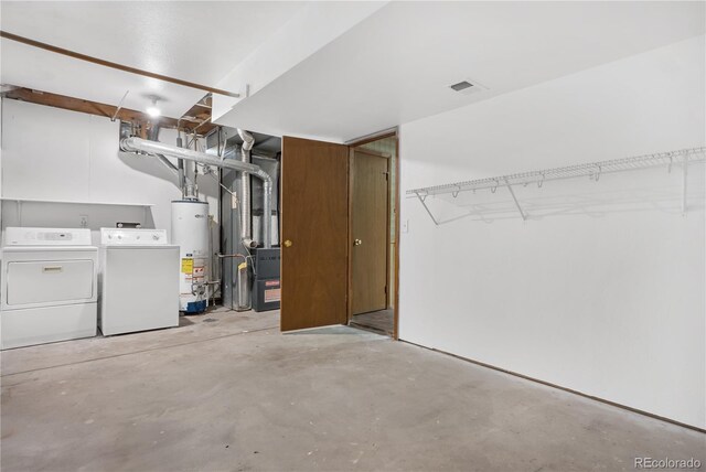 interior space with heating unit, washer and dryer, and gas water heater