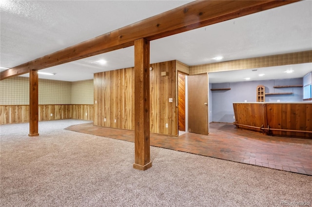 basement with wood walls and carpet