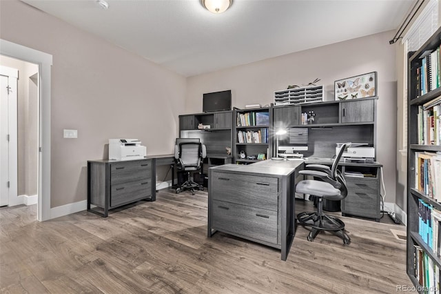office space with wood finished floors and baseboards