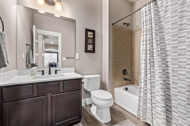 full bathroom featuring wood finished floors, vanity, toilet, shower / bathtub combination with curtain, and a textured wall
