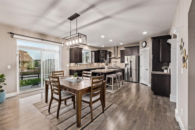 dining space featuring dark wood-style flooring, recessed lighting, and baseboards