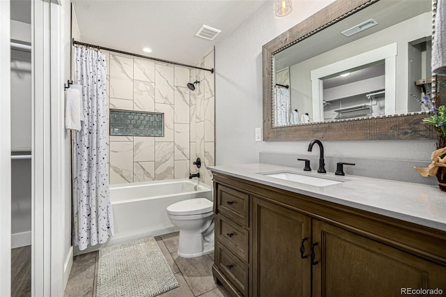 full bath with vanity, toilet, and shower / bath combo