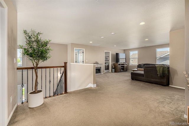 living room with carpet floors, baseboards, and recessed lighting