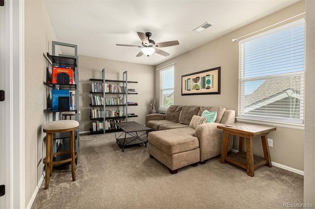 living area with carpet floors, ceiling fan, and baseboards
