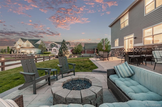 view of patio / terrace featuring an outdoor living space with a fire pit and a residential view