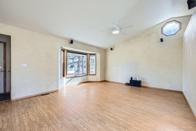 unfurnished living room with vaulted ceiling, light hardwood / wood-style flooring, and ceiling fan