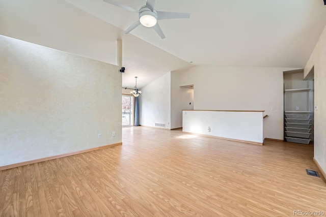 unfurnished living room featuring ceiling fan with notable chandelier, light hardwood / wood-style flooring, and lofted ceiling