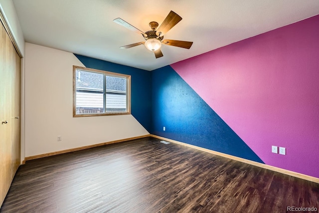 empty room featuring ceiling fan and dark hardwood / wood-style floors