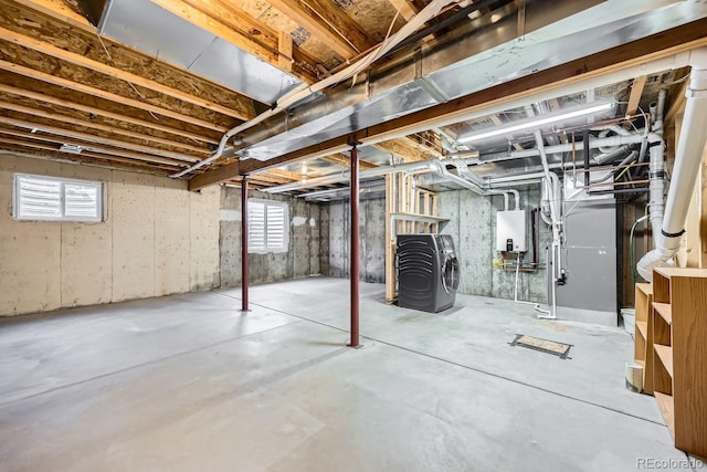 basement with tankless water heater and washer / clothes dryer