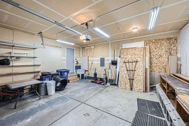 garage with electric panel and a garage door opener