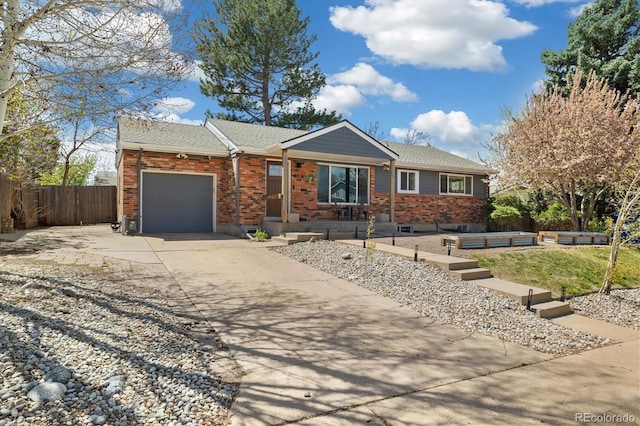 882 E Briarwood Cir, Centennial, CO 80122 - ranch-style home featuring an attached garage, fence, brick siding, and concrete driveway