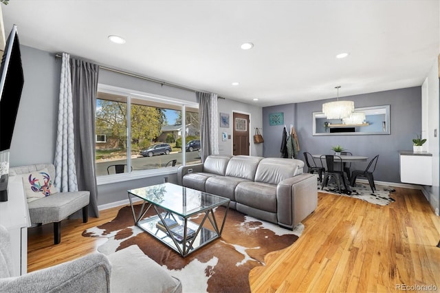882 E Briarwood Cir, Centennial, CO 80122 - living room featuring recessed lighting, baseboards, light wood finished floors, and a notable chandelier