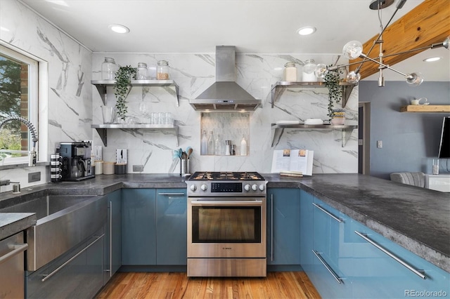 882 E Briarwood Cir, Centennial, CO 80122 - kitchen featuring wall chimney range hood, open shelves, stainless steel appliances, decorative backsplash, and blue cabinets