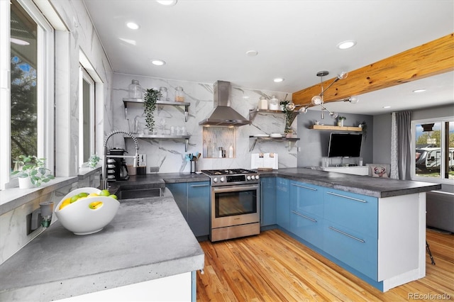 882 E Briarwood Cir, Centennial, CO 80122 - kitchen with open shelves, wall chimney exhaust hood, stainless steel gas stove, and blue cabinetry