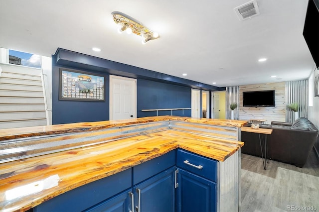 882 E Briarwood Cir, Centennial, CO 80122 - kitchen with visible vents, butcher block countertops, open floor plan, light wood-style floors, and blue cabinetry