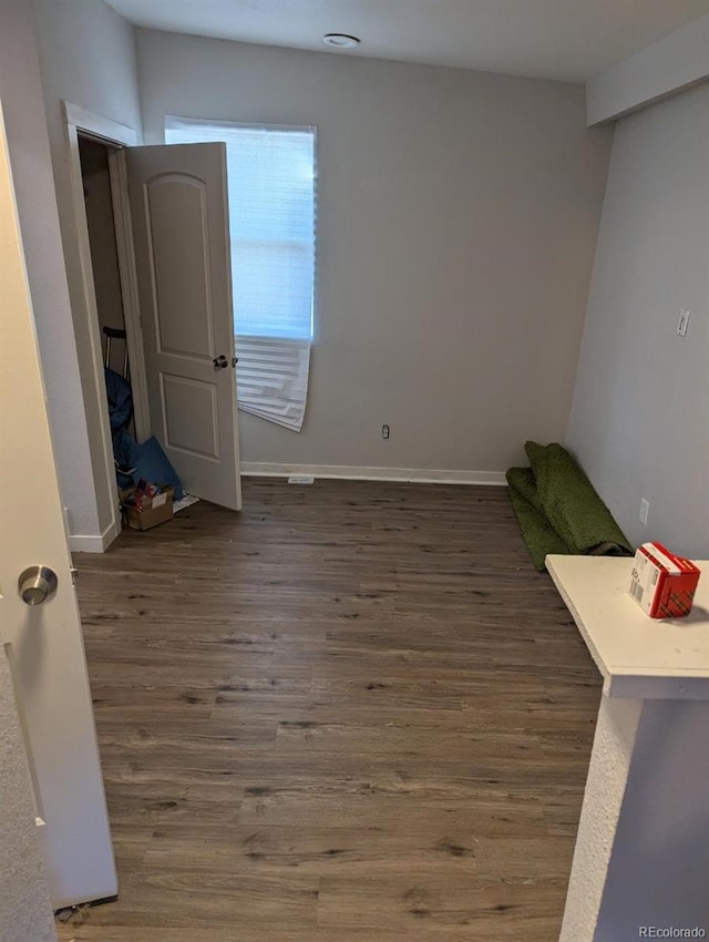 spare room with dark wood-type flooring