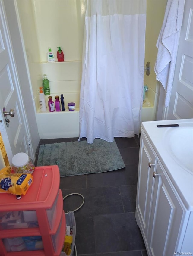 bathroom featuring tile patterned flooring, vanity, and shower / tub combo with curtain