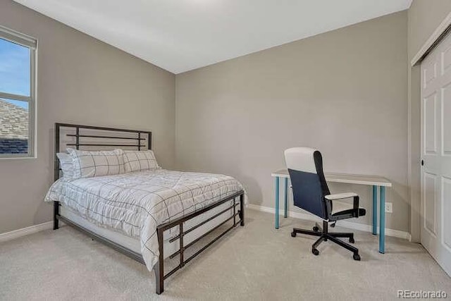 bedroom with baseboards and carpet floors