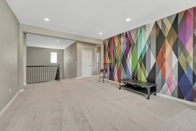 interior space featuring wallpapered walls, an accent wall, baseboards, carpet floors, and recessed lighting