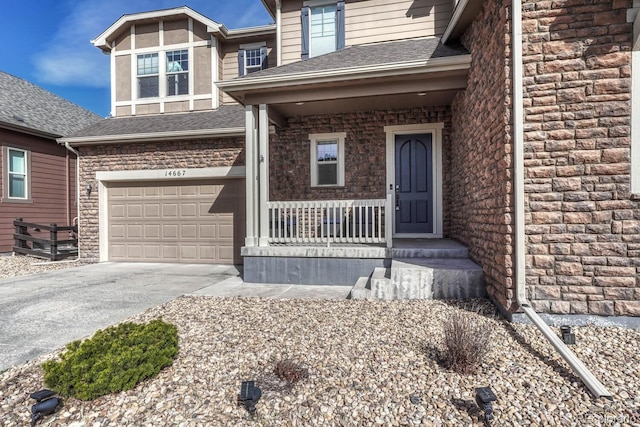 property entrance with covered porch, concrete driveway, and roof with shingles