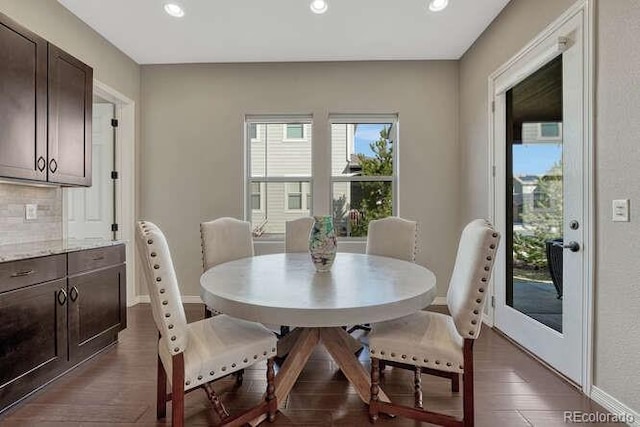 dining area with dark wood finished floors, recessed lighting, and baseboards