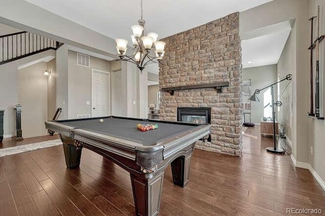 game room with wood finished floors, visible vents, baseboards, a stone fireplace, and pool table